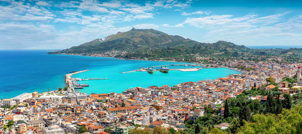 High angle view of sea and townscape against sky