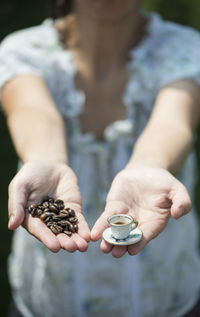 Midsection of man holding coffee