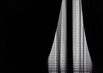 Low angle view of curtain in dark room