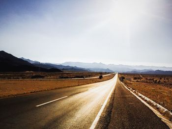 Empty road leading towards mountains