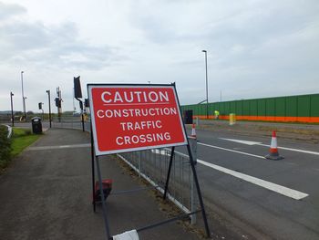Road sign against sky