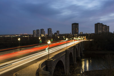 Light trails of traffic crossing a bridge in the twilight evening.