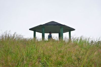 Man standing on field against sky