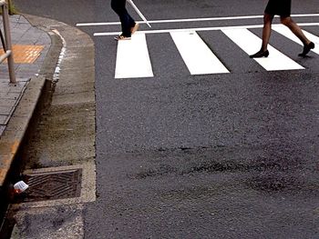 Low section of people walking on road