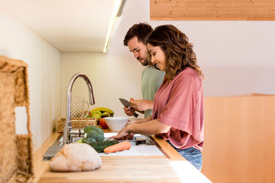 Couple preparing food together in kitchen at home