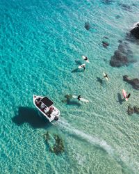 High angle view of people swimming in sea