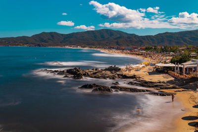 Scenic view of sea and mountains against sky