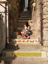 Woman sitting on staircase