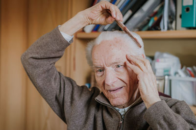 Portrait of man wearing hat at home