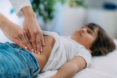 Pediatrician gastroenterologist, examining preschooler boys abdomen.