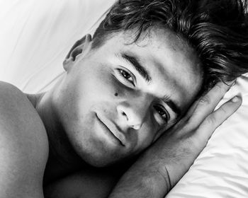 Close-up portrait of man relaxing on bed