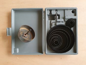 Directly above shot of old tools in box on table