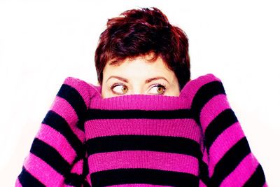 Portrait of man covering face against white background