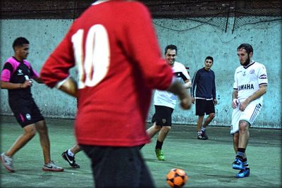 Group of people playing soccer ball