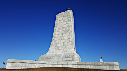 Low angle view of monument against clear blue sky