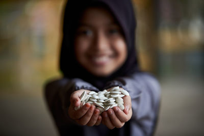 Close-up of woman holding seashells