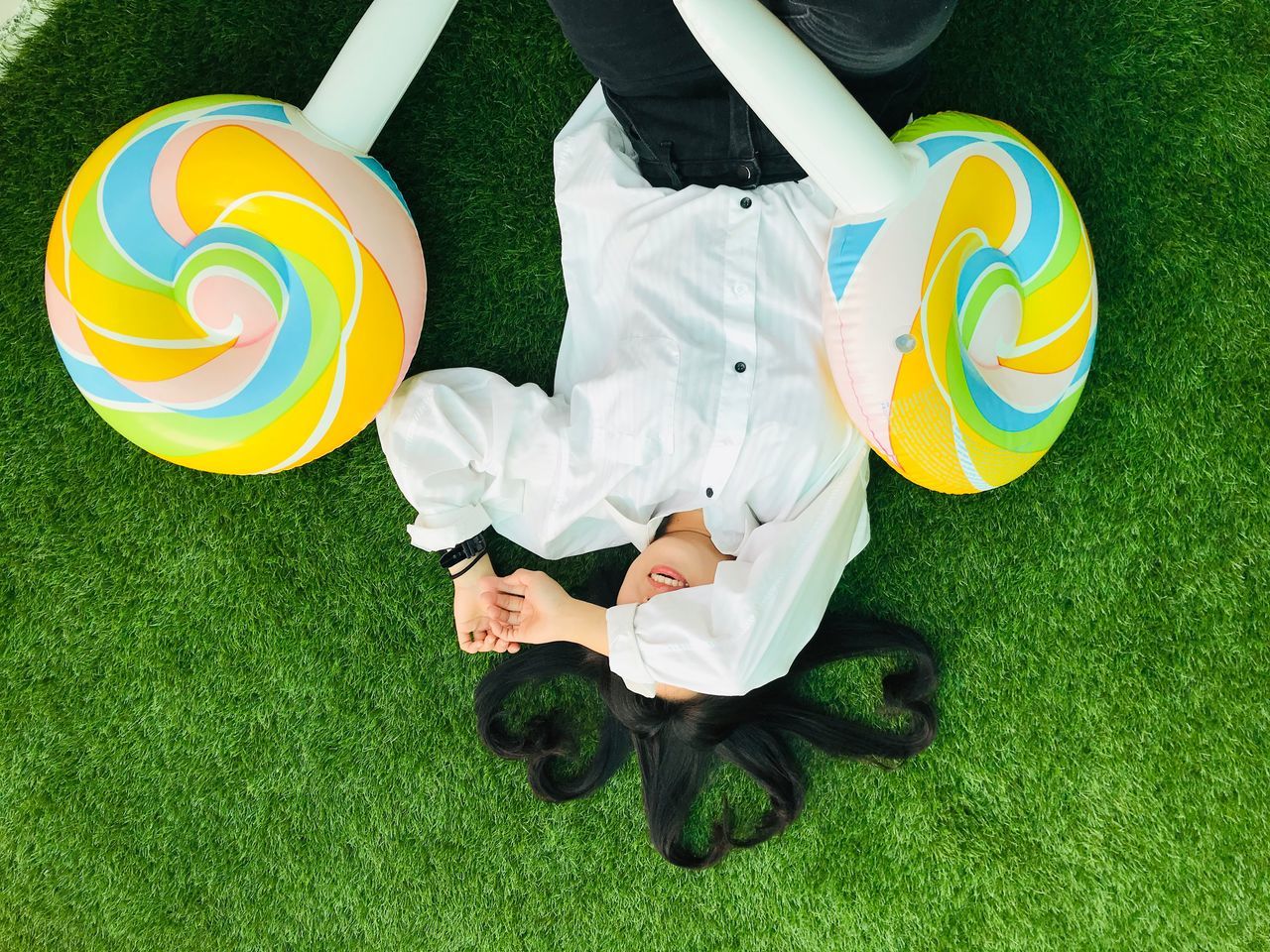 HIGH ANGLE VIEW OF PERSON WITH TOY ON FIELD