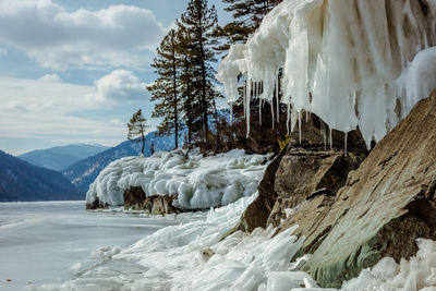 View of beautiful drawings on ice from cracks on the surface of lake teletskoye in winter, russia