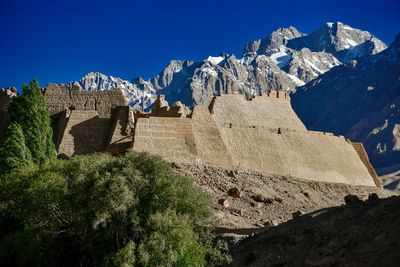 Scenic view of mountains against clear blue sky