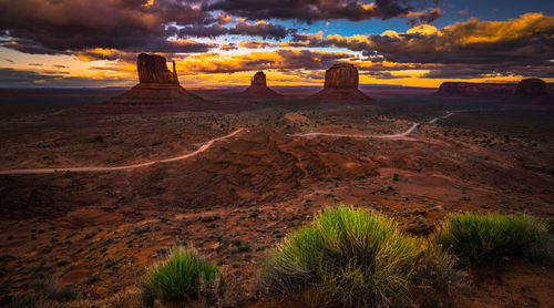 Landscape against cloudy sky during sunset