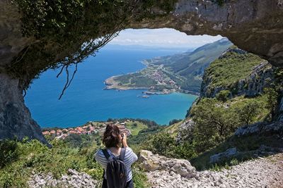 Rear view of woman looking at view of mountains