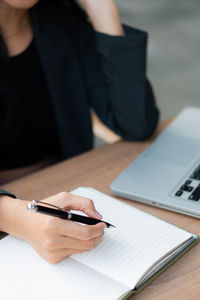 Midsection of woman working at table