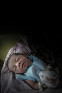 Portrait of cute boy sleeping on bed