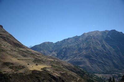 Scenic view of mountains against clear blue sky