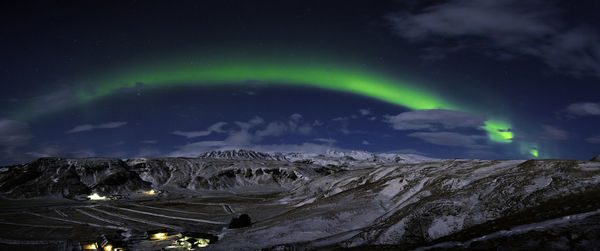 Scenic view of snowy landscape against aurora at night