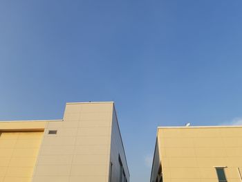 Low angle view of building against blue sky