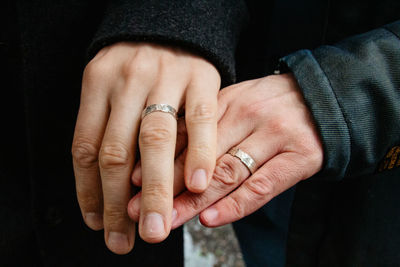 Midsection of man holding hands