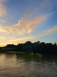 Scenic view of lake against sky at sunset