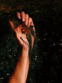 Close-up of person hand in mud