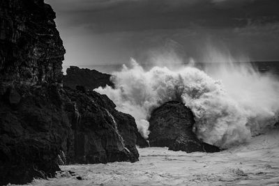 Scenic view of rocks and sea against sky