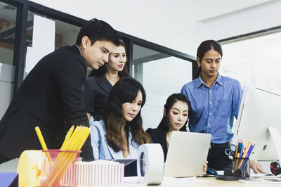 Colleagues at desk in office