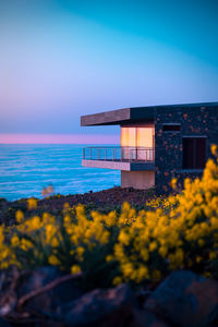 Building in a hill near ocean under blue clear sky