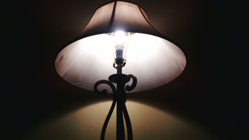 Low angle view of lamp lit up at night