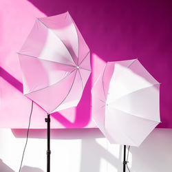 Close-up of multi colored umbrellas against white background