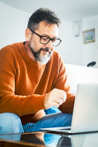 Young man using laptop at home