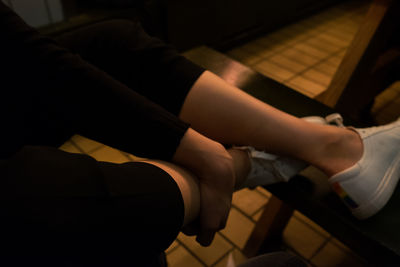 Low section of woman sitting on floor