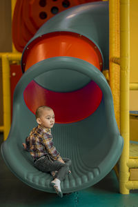 Cute boy sitting on balloons