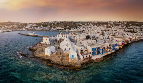 High angle view of townscape by sea against sky