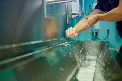 Midsection of person preparing food in kitchen