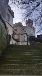 Low angle view of staircase by building against sky