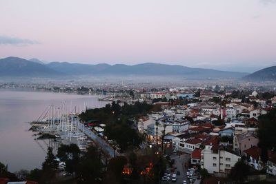 High angle view of buildings by city against sky during sunset