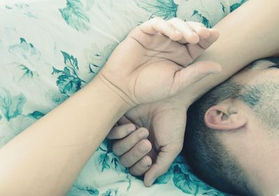 Cropped image of man sleeping on bed