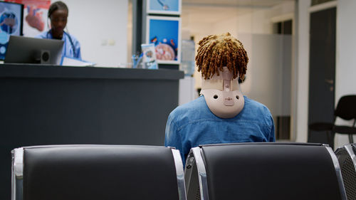 Rear view of woman sitting in train