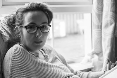 Close-up of girl sitting in eyeglasses