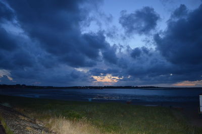 Scenic view of sea against cloudy sky