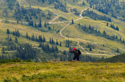 Man standing on road in forest